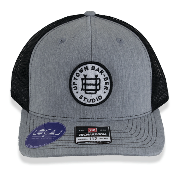 Grey and black trucker hat with round logo patch