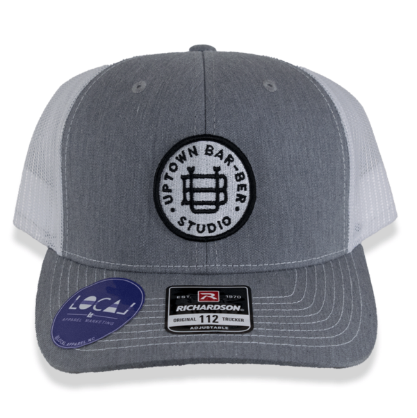 Grey and white trucker hat with round logo patch